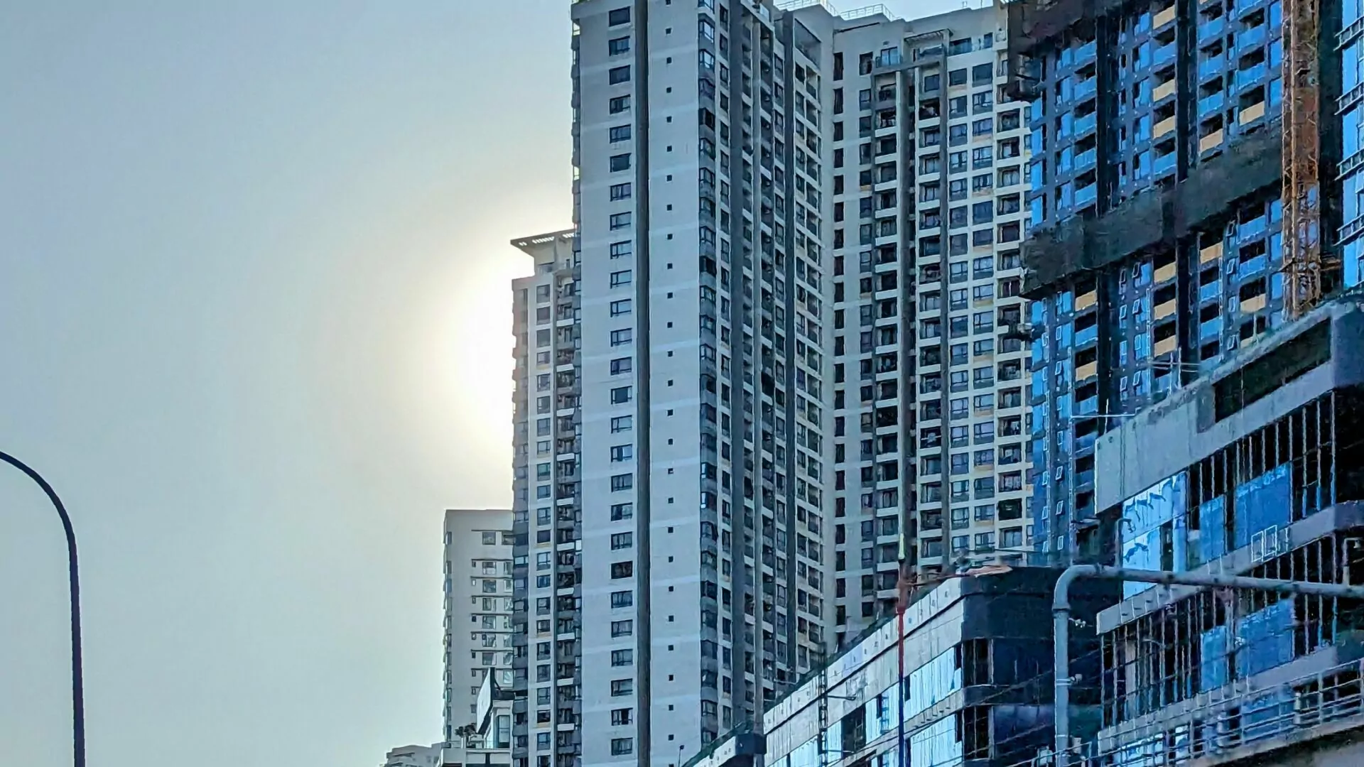 Passing the Lumière Riverside construction site in District 2, with Line 1 of the Ho Chi Minh City Metro in the foreground.