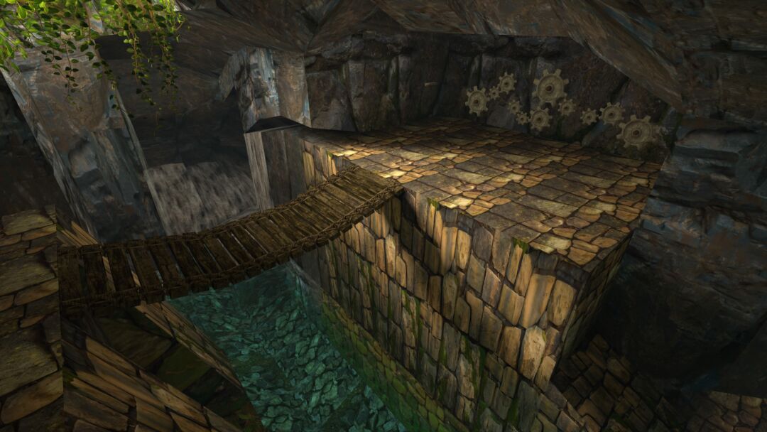 This screenshot shows a bridge over a river leading to a gear riddle on a cave wall from Tomb Raider 1 Remastered. It features the remastered graphics.