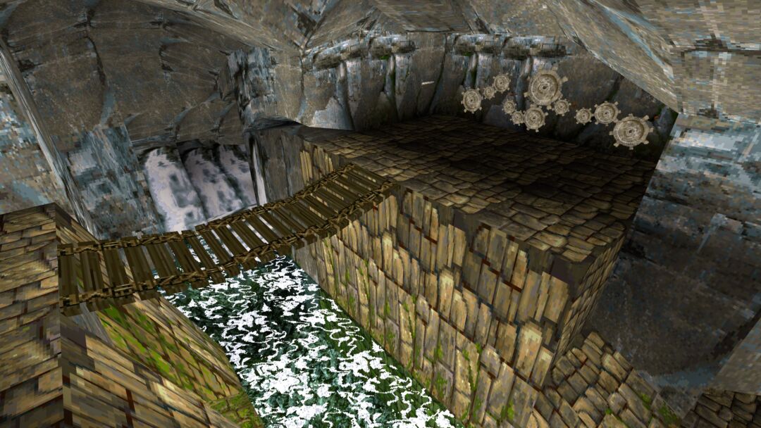 This screenshot shows a bridge over a river leading to a gear riddle on a cave wall from Tomb Raider 1 Remastered. It features the original 1996 graphics.