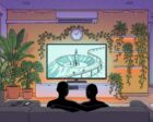 Two figures seen from behind on a dark sofa watching a TV that shows a volcano lair with a rocket and a monorail, the screen framed by tropical houseplants, an orange LED strip under the cabinet, fairy lights across a violet ceiling and candle jars on a small round table